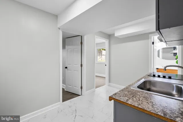 a kitchen that has a sink and a stove