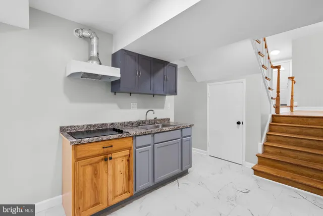 a kitchen with stainless steel appliances granite countertop a stove and a sink