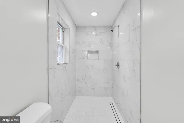 a bathroom with a toilet and shower