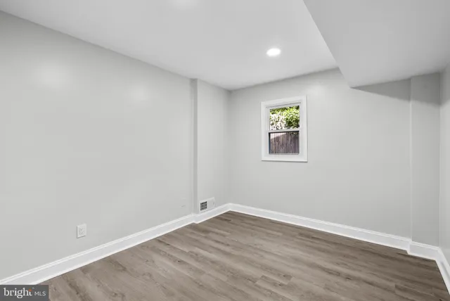 a view of room with wooden floor and window