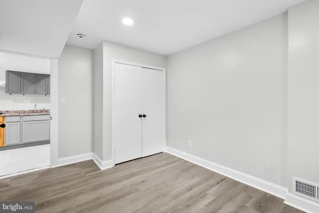 a view of a kitchen with wooden floor and a sink