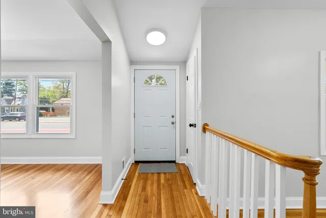 a view of a bedroom with wooden floor and a bed