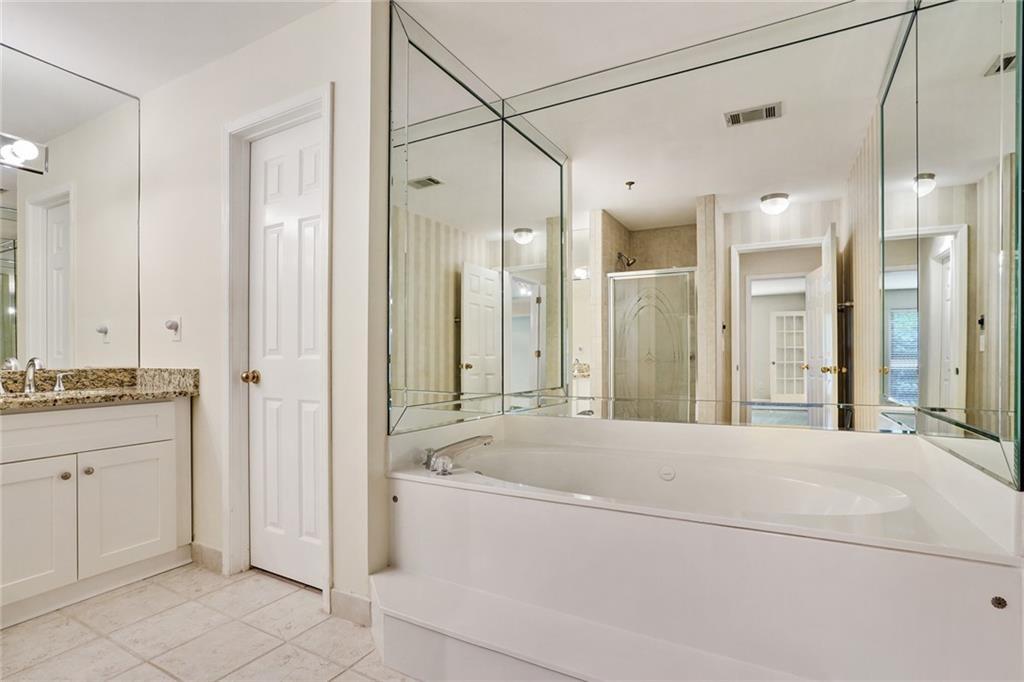 3203 Lenox Road Northeast, Unit 6 Atlanta, GA 30324 - Photo 12 of 27 a bathroom with a granite countertop sink mirror and a shower