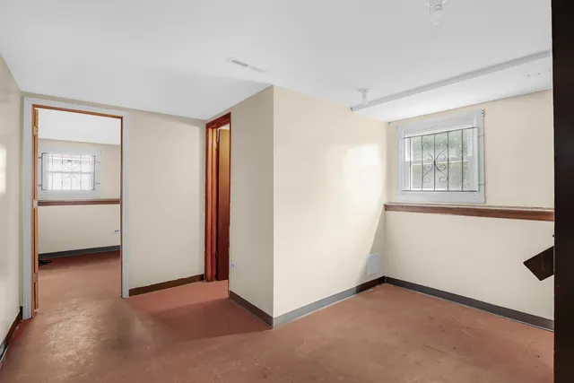 an empty room with windows and closet