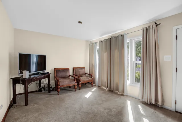 a view of a livingroom with workspace and a window
