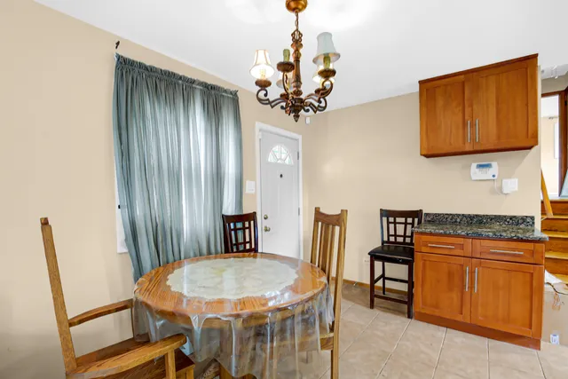 a view of a dining room with furniture and a chandelier