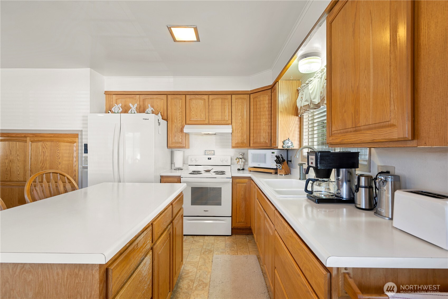 915 128th Street Southwest Everett, WA 98204 - Photo 11 of 25 a kitchen with stainless steel appliances a refrigerator a sink a stove and white cabinets