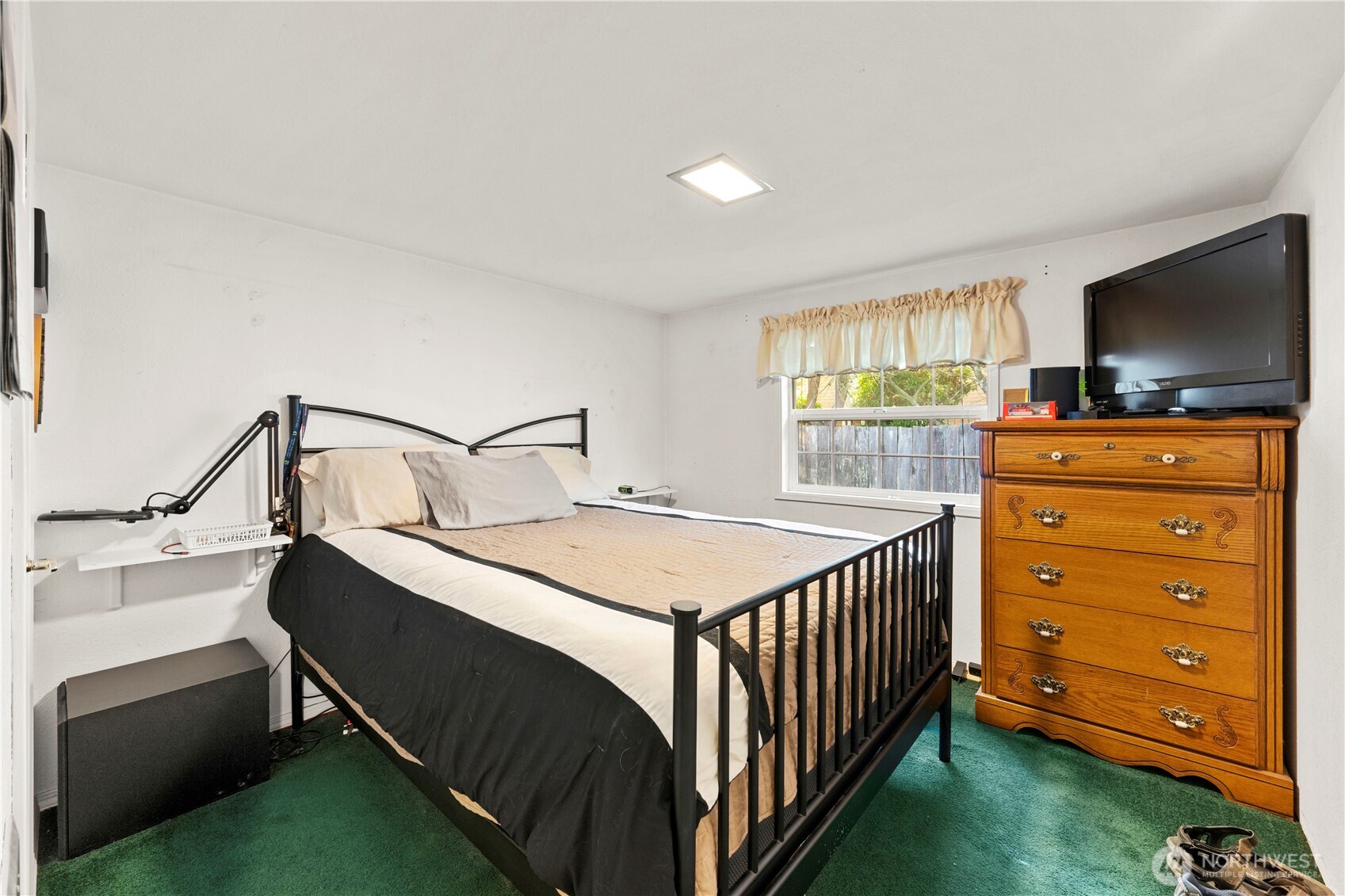 915 128th Street Southwest Everett, WA 98204 - Photo 16 of 25 a bedroom with a bed and a flat tv screen on dresser
