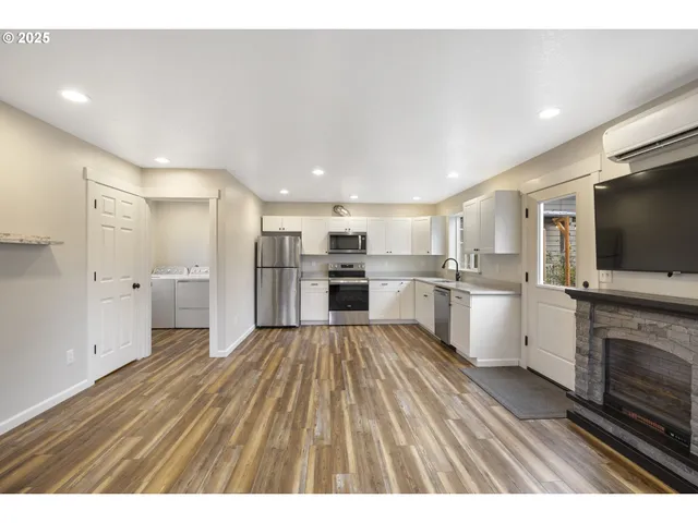 a view of kitchen with sink microwave refrigerator and cabinets