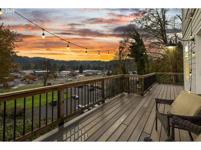 a view of balcony with wooden floor and fence
