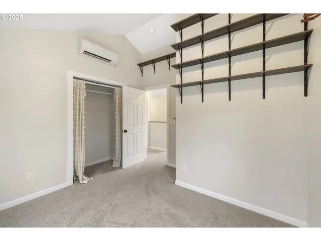 an empty room with windows and ceiling fan