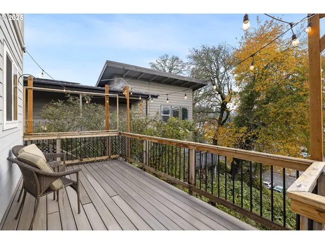 a view of balcony with wooden floor and outdoor seating