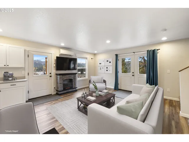 a living room with furniture flat screen tv and a fireplace
