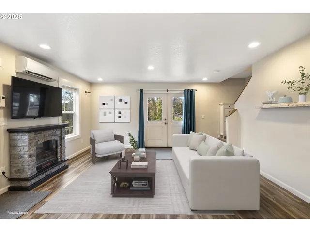 a living room with furniture flat screen tv and a fireplace
