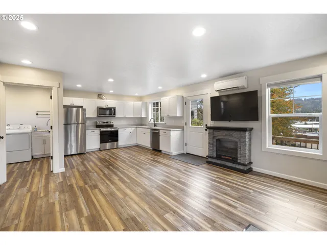 a view of kitchen with microwave oven stove and refrigerator