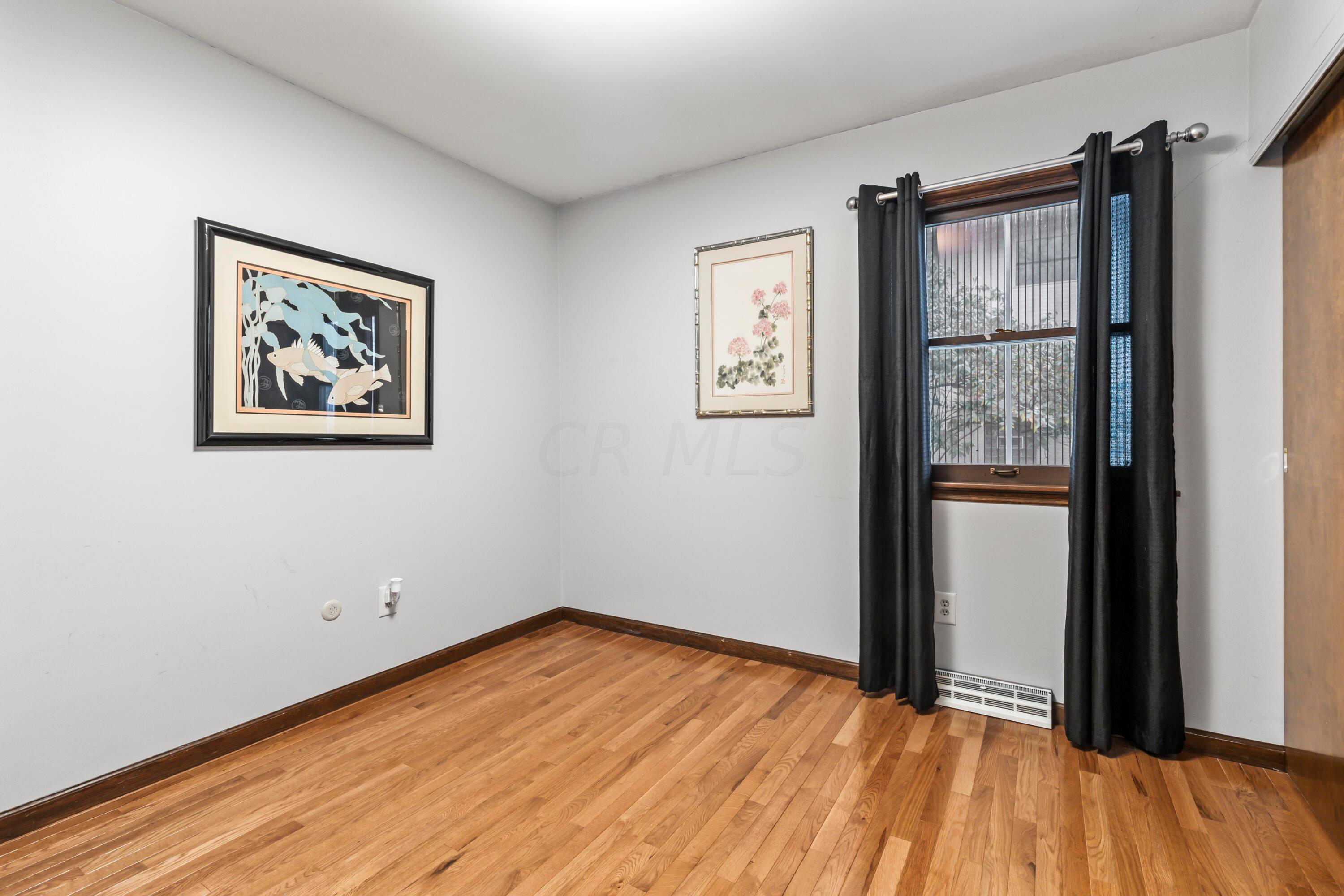 7020 Rieber Street Columbus, OH 43085 - Photo 29 of 40 • New hardwood flooring ~ 2013 • Grey painted walls • New ceiling light ~ 2017 • Drapes are negotiable • Closet with double sliding doors