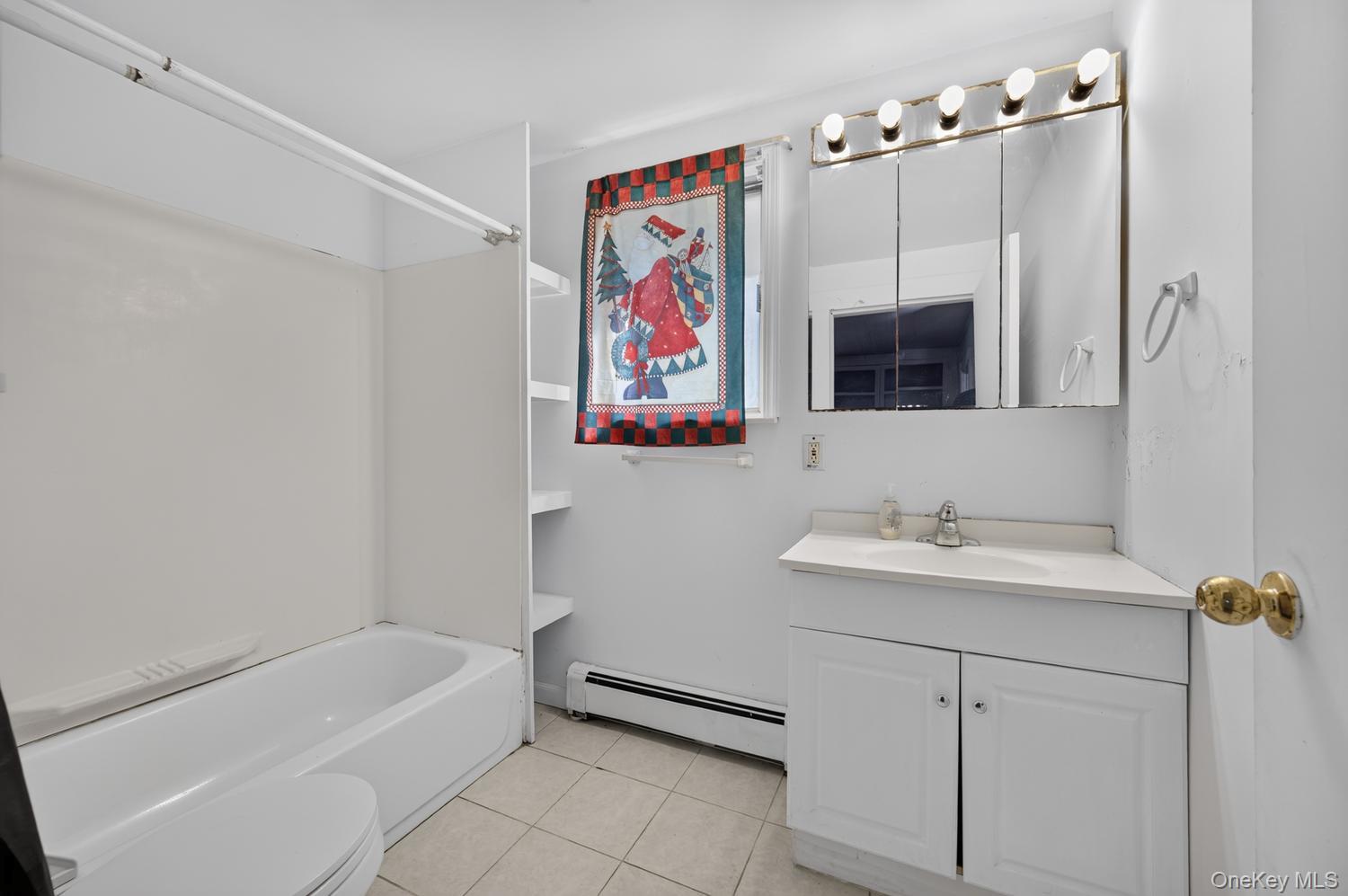 49 Cedar Street Babylon, NY 11702 - Photo 16 of 20 a bathroom with a sink and a mirror