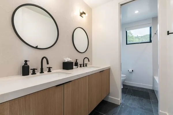 a bathroom with a double vanity sink and a mirror