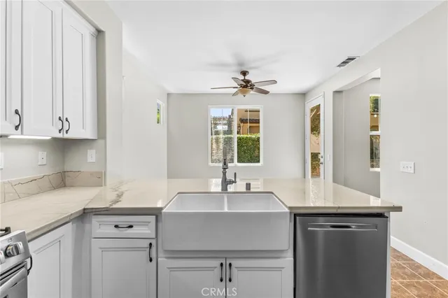a sink with a window and cabinets