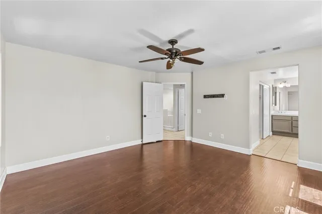 an empty room with fan and entrance