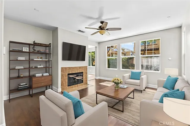 a living room with furniture a fireplace and a flat screen tv