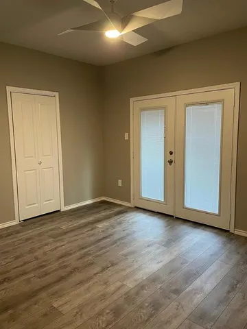 a view of an empty room and wooden floor
