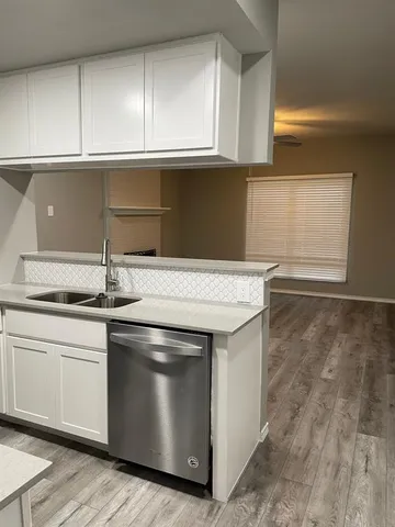 a kitchen with granite countertop a sink and a stove