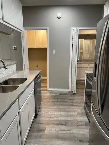 a kitchen with a sink and refrigerator