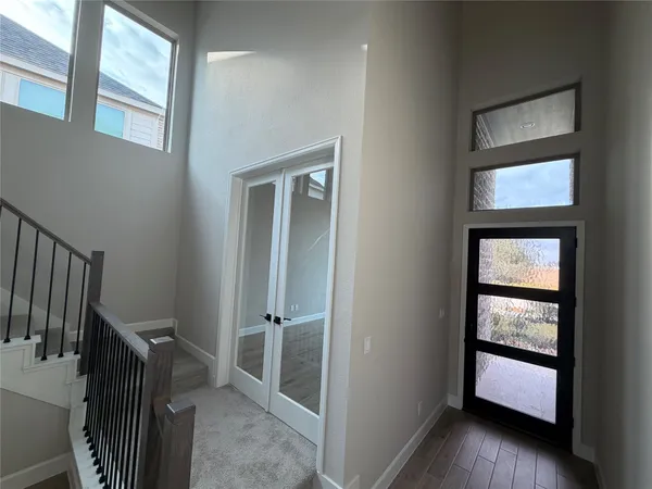 a view of entryway and hall with wooden floor