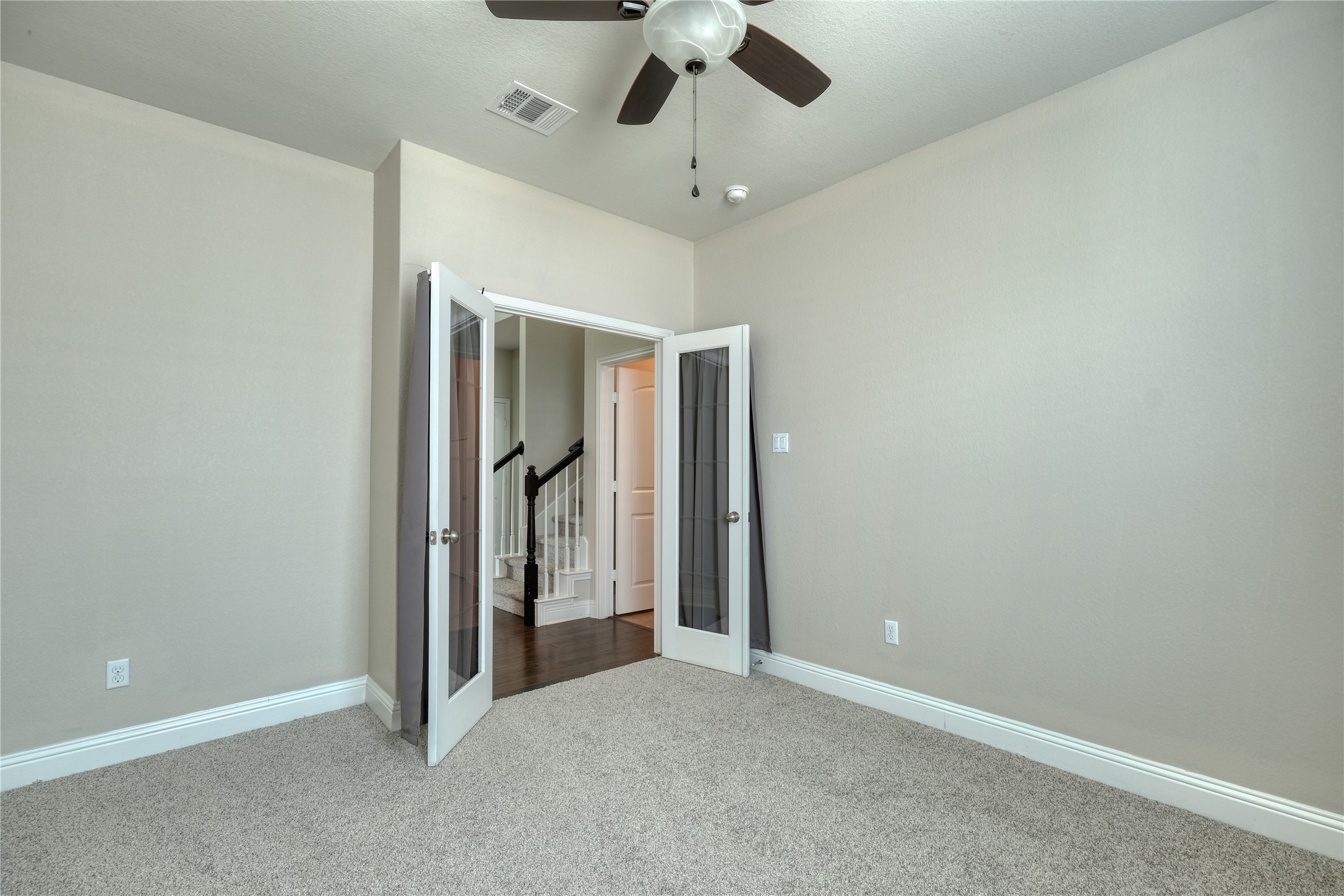 1804 Elaina Loop Leander, TX 78641 - Photo 8 of 12 Unfurnished bedroom featuring french doors, carpet floors, and ceiling fan