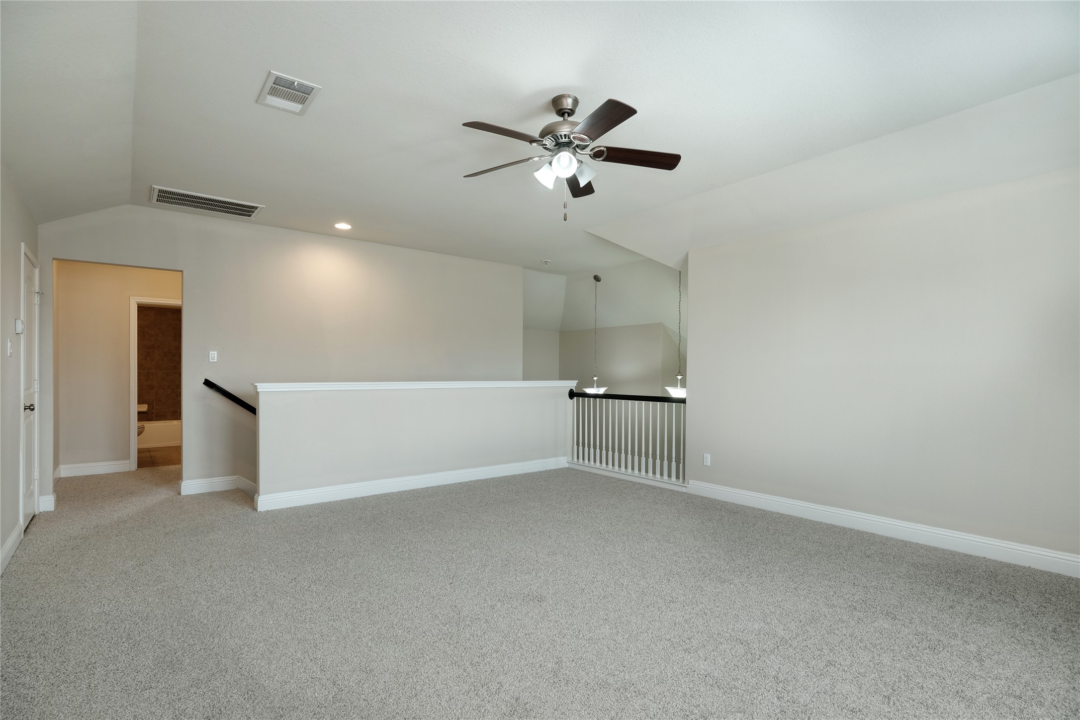 1804 Elaina Loop Leander, TX 78641 - Photo 9 of 12 Empty room featuring light carpet, ceiling fan, lofted ceiling, and recessed lighting