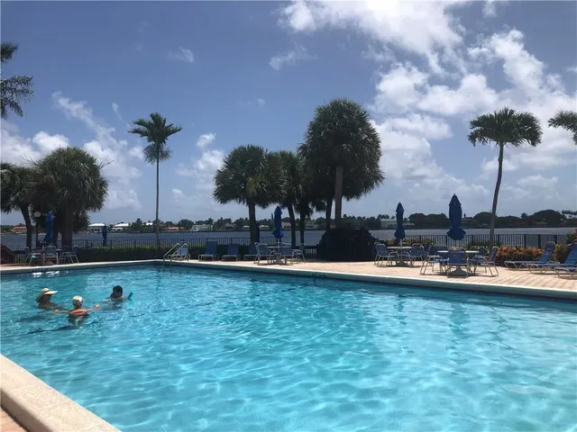 a view of a swimming pool and lounge chairs