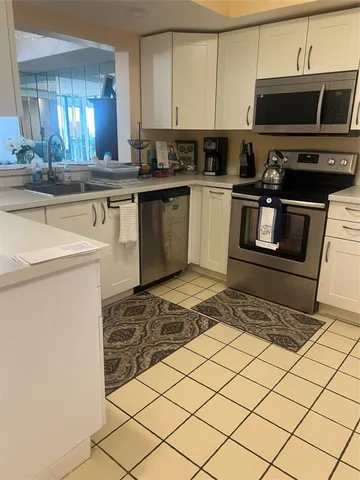 a kitchen with a sink and a stove top oven