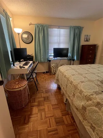 a bedroom with a bed and a television