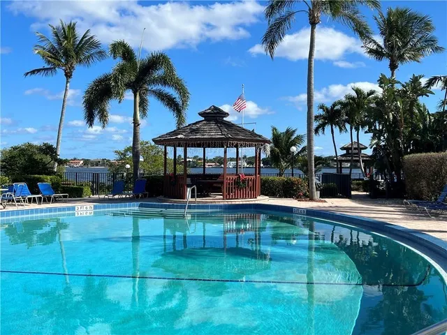 a swimming pool view with a garden