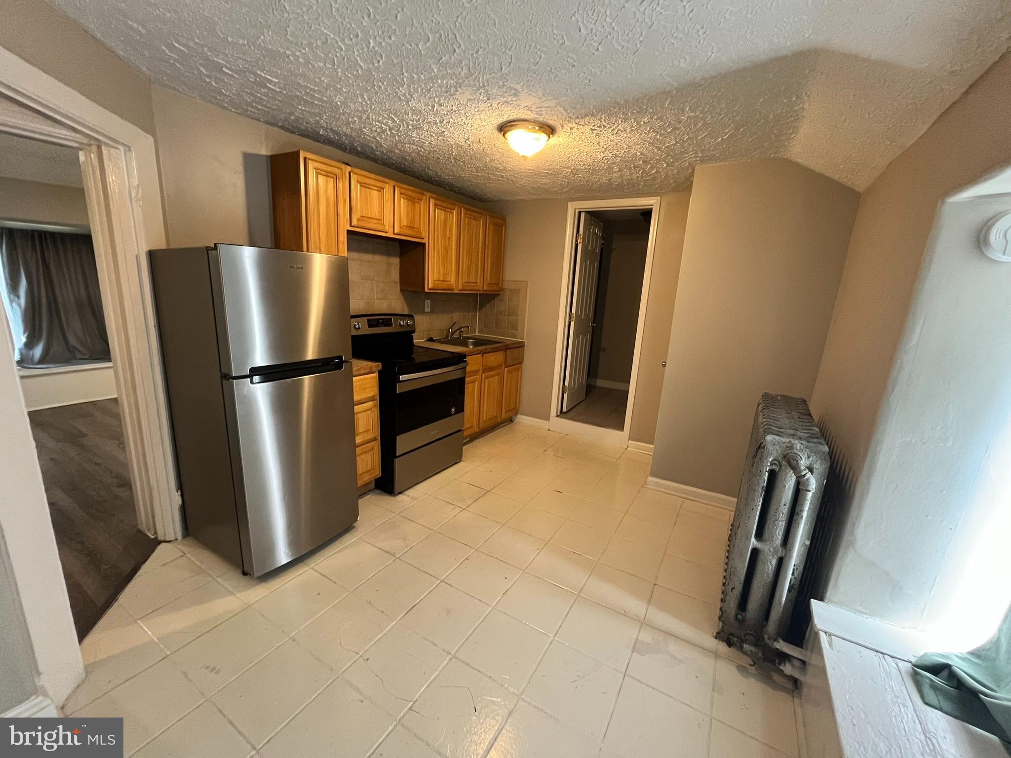 14 Tansboro Road, Unit 3 Berlin, NJ 08009 - Photo 4 of 7 a kitchen with stainless steel appliances a refrigerator sink and wooden floor