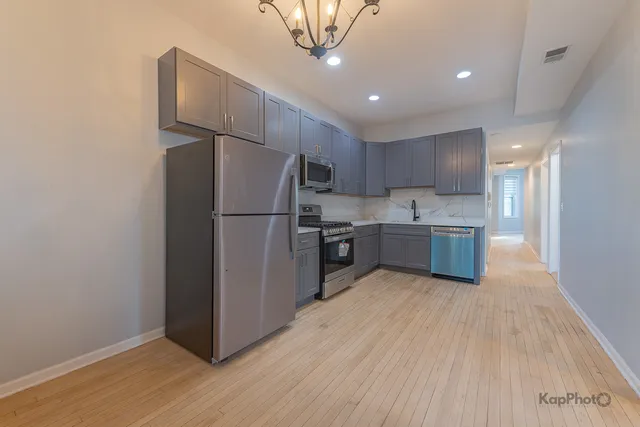 a kitchen with stainless steel appliances a refrigerator and a sink