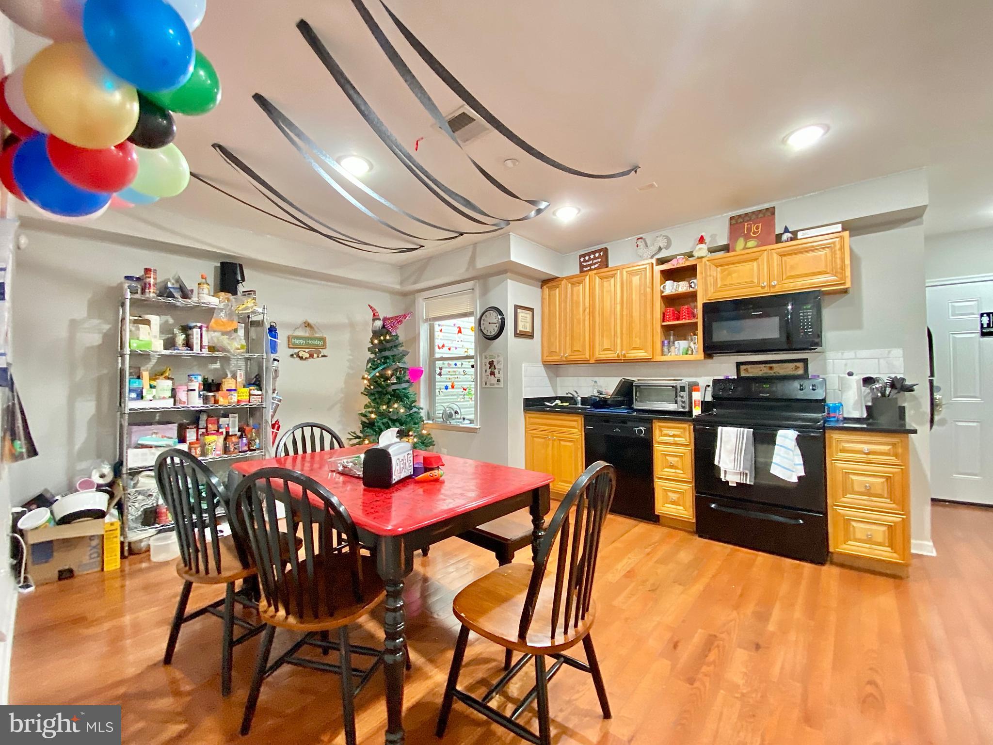 a kitchen with stainless steel appliances kitchen island granite countertop a dining table chairs and granite counter tops