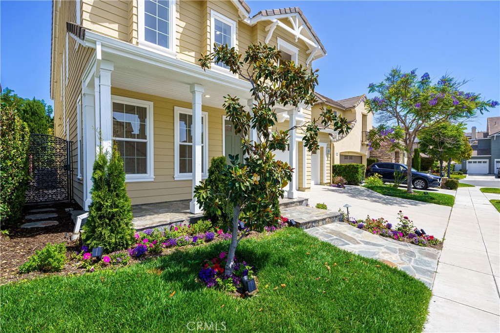 15 Plum Street Ladera Ranch, CA 92694 - Photo 3 of 113 a view of a white house with a big yard and potted plants