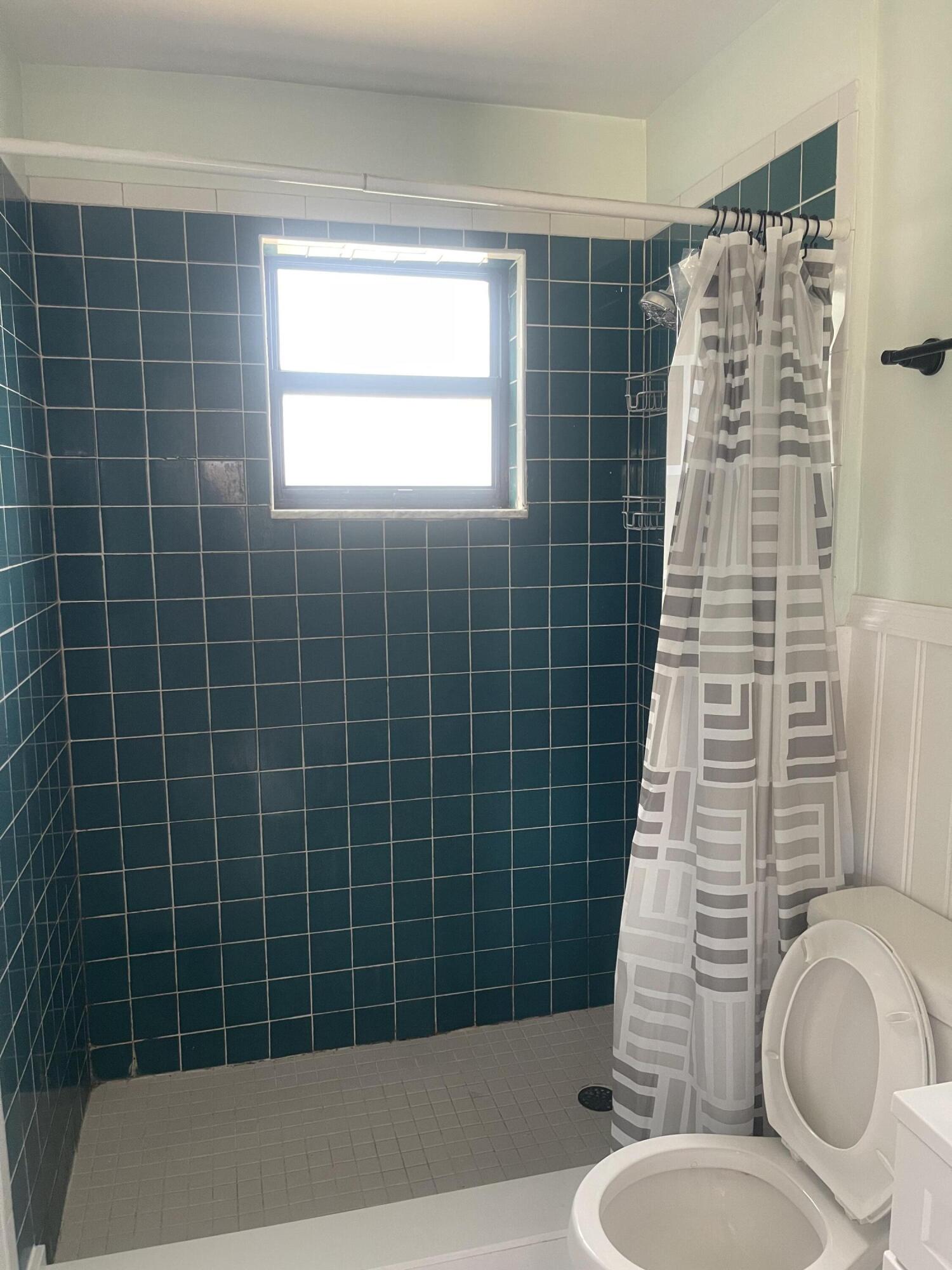 1081 Southeast Monterey Road, Unit 331 Stuart, FL 34994 - Photo 11 of 12 a bathroom with a sink toilet and shower