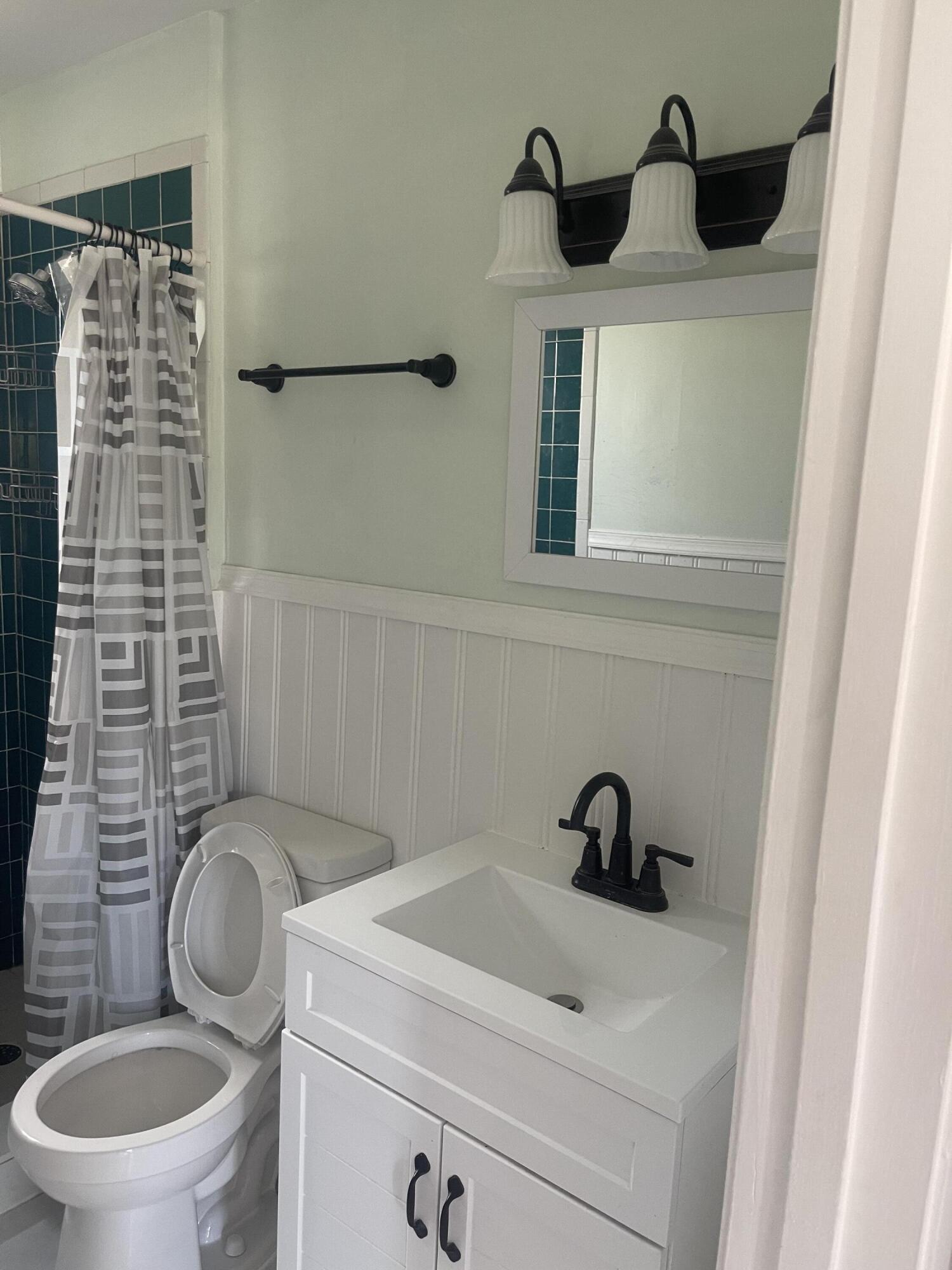 1081 Southeast Monterey Road, Unit 331 Stuart, FL 34994 - Photo 12 of 12 a bathroom with a toilet and a sink