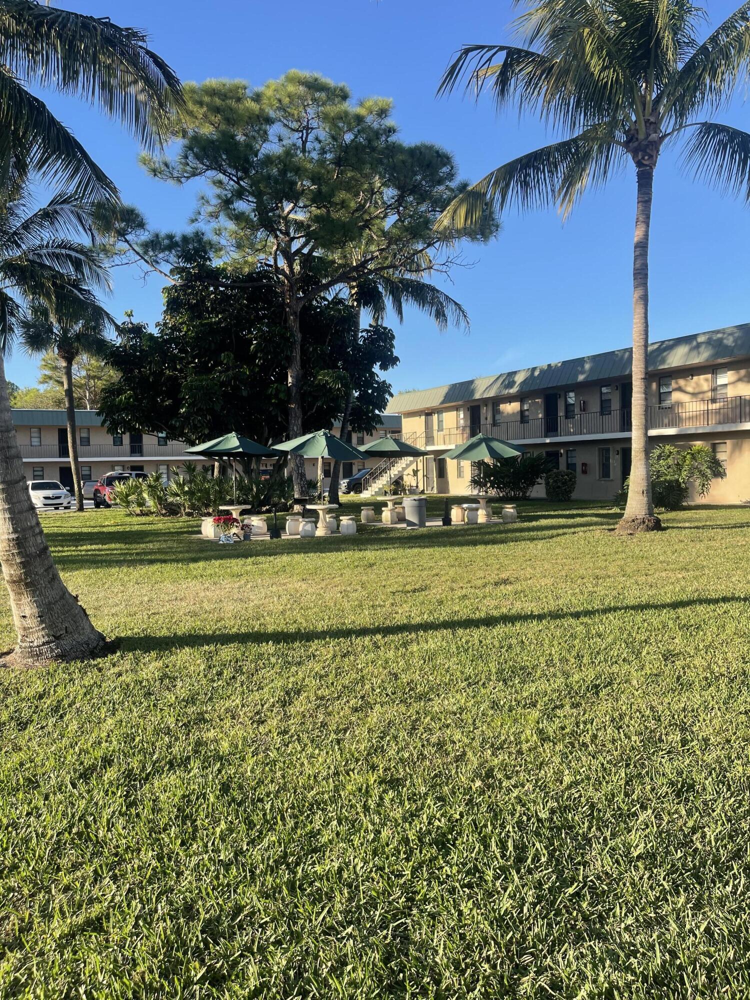 1081 Southeast Monterey Road, Unit 331 Stuart, FL 34994 - Photo 2 of 12 a view of a house with a yard