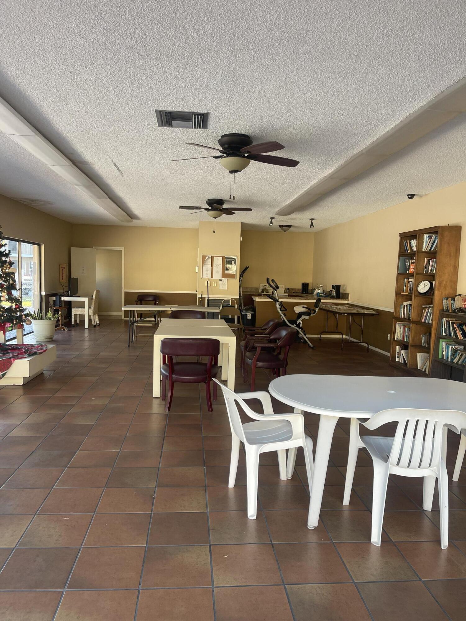 1081 Southeast Monterey Road, Unit 331 Stuart, FL 34994 - Photo 5 of 12 a group of chairs sitting in kitchen and dining room