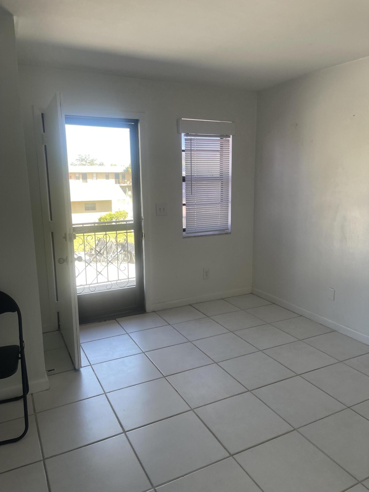 1081 Southeast Monterey Road, Unit 331 Stuart, FL 34994 - Photo 6 of 12 an empty room with windows