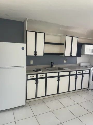 a kitchen with stainless steel appliances granite countertop a sink and a stove