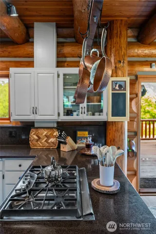 a kitchen with a stove and a wooden floor