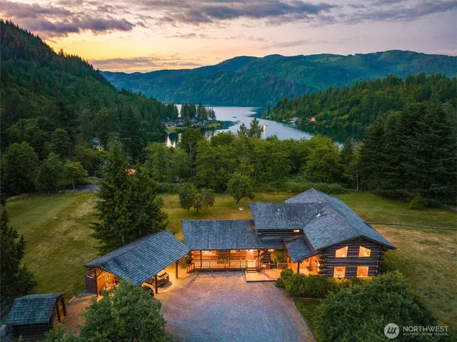 an aerial view of residential houses with outdoor space and lake view