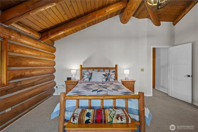 a bedroom with furniture and large windows