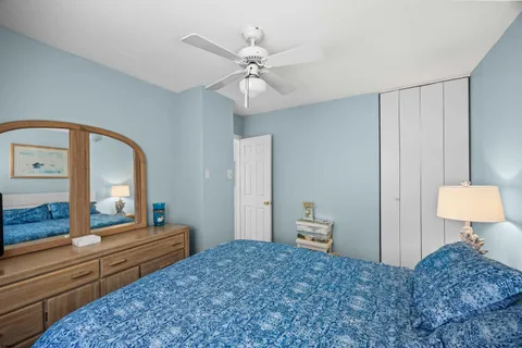 a view of a roof deck with table and chairs with wooden floor and fence