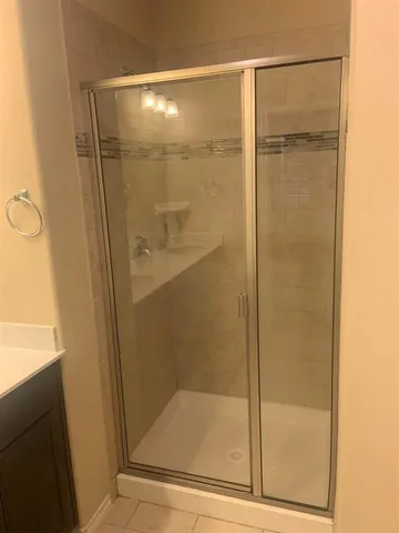 a bathroom with a glass shower door